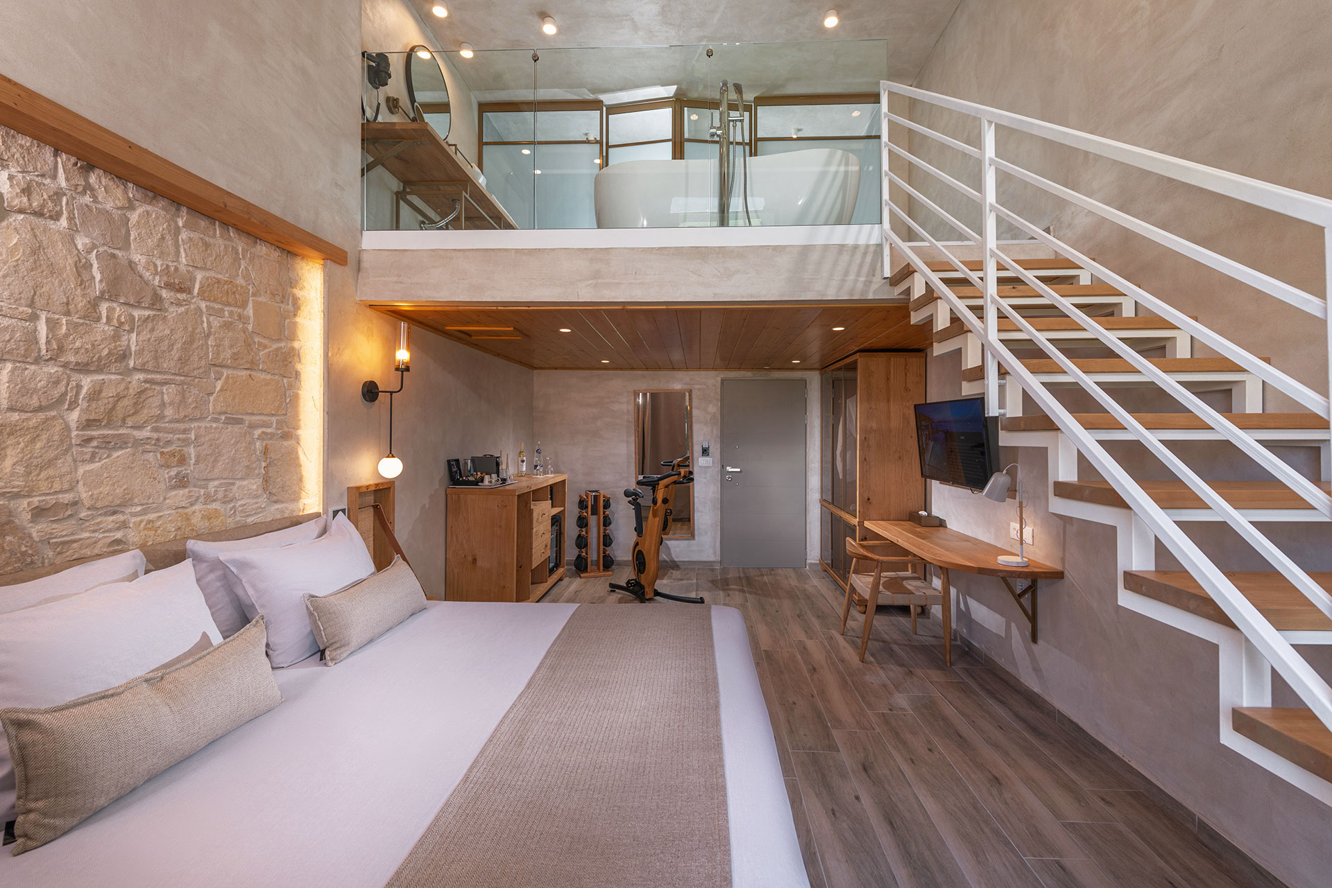 Loft room bed and stairs leading to the bathroom